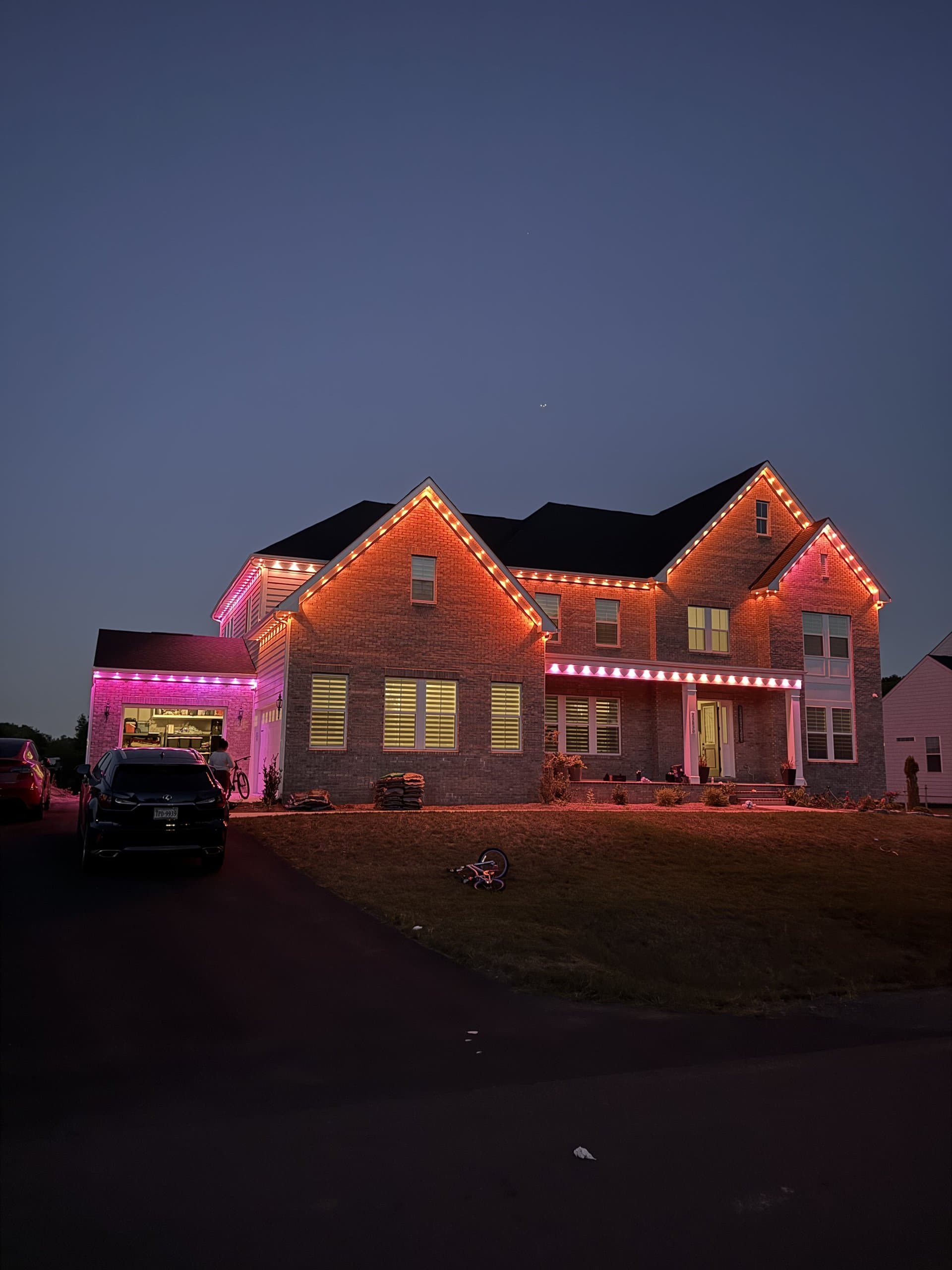 Spark Address crew installing permanent LED lighting on a home